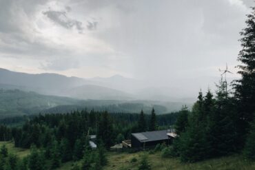Modern off-grid cabin powered by rooftop solar panels in a forest