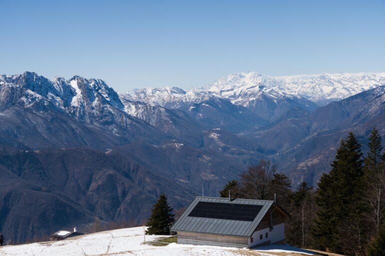 Modern off-grid cabin powered by rooftop solar panels on a mountain